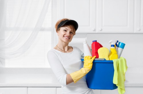 Carpet cleaning technician preparing equipment in a property